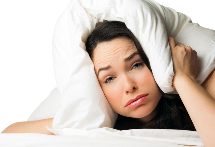 Woman with pillow tired from adrenal fatigue